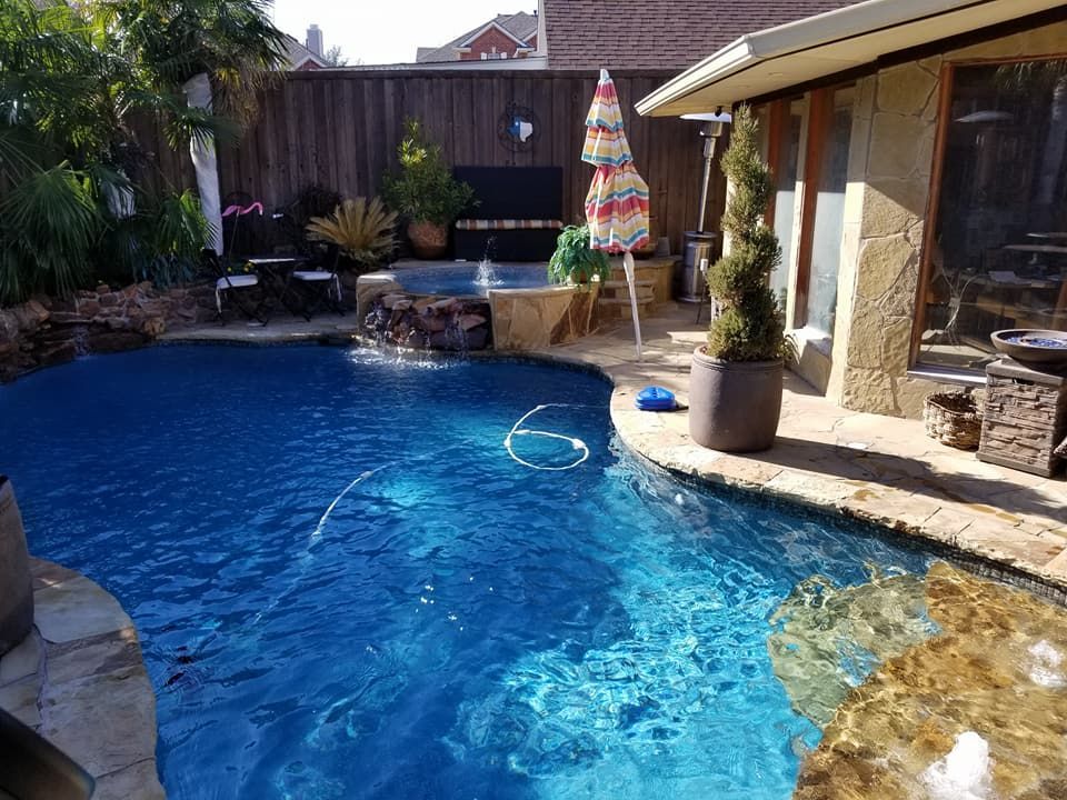 A large swimming pool in the backyard of a house.