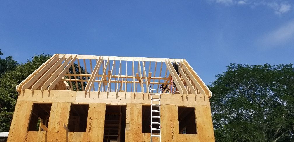 A house under construction with a ladder on top of it