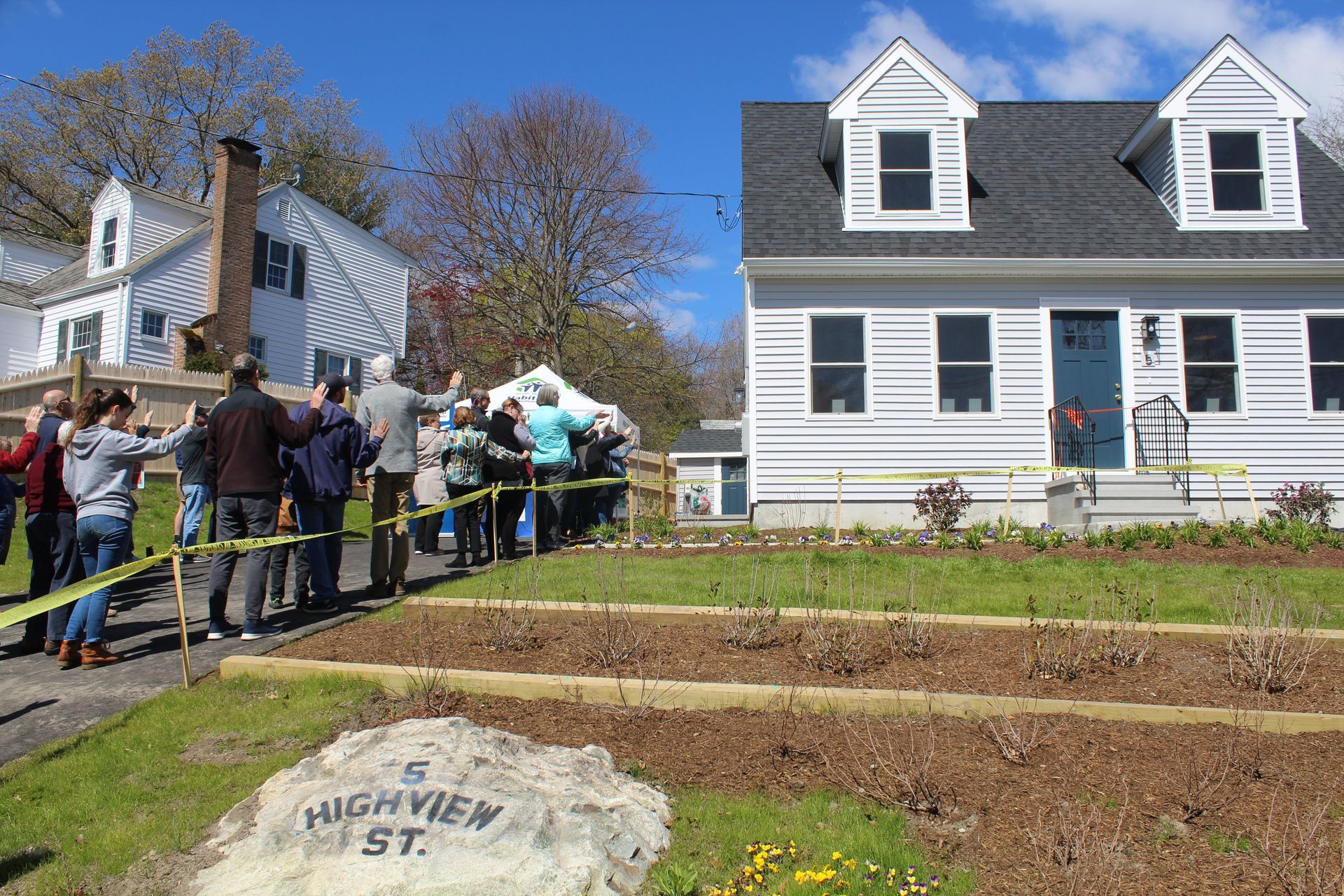 A group of people standing in front of a house on highview st.
