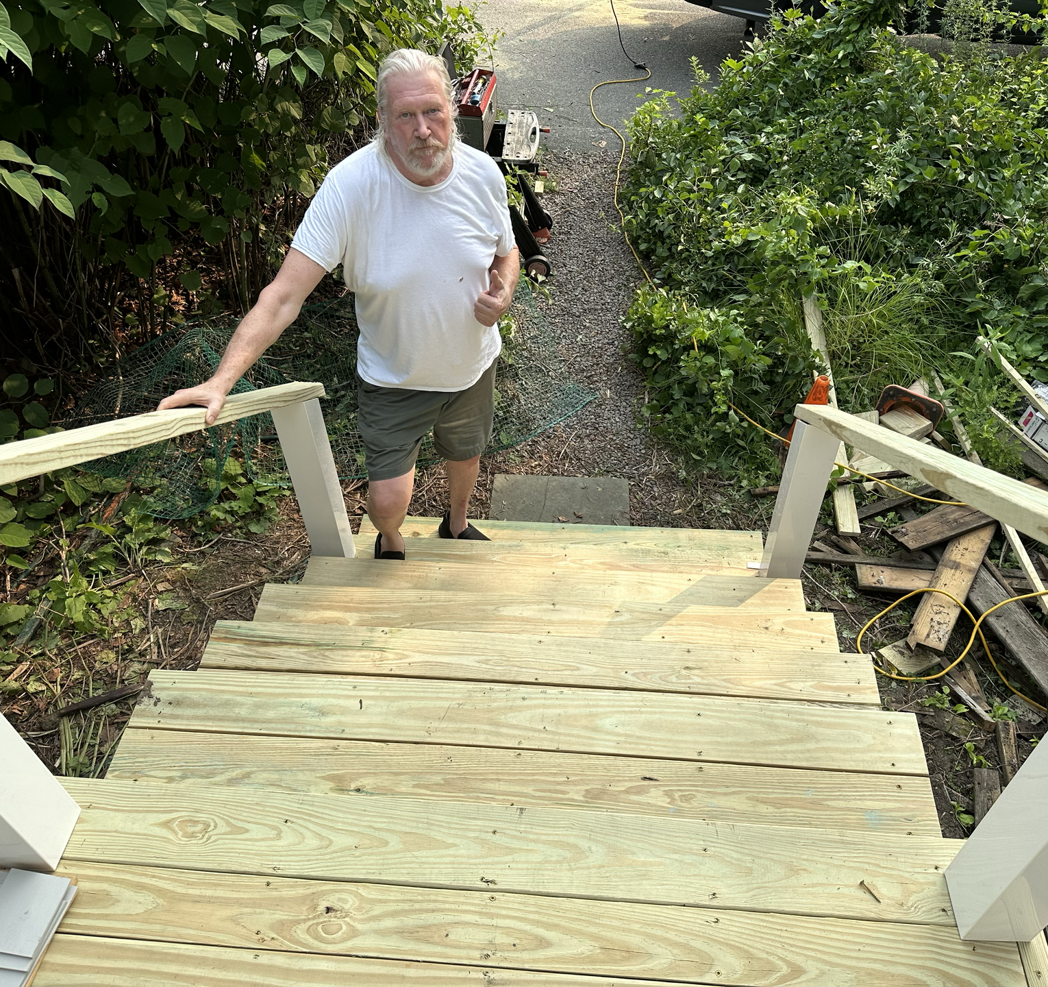 A man is walking up a set of wooden stairs