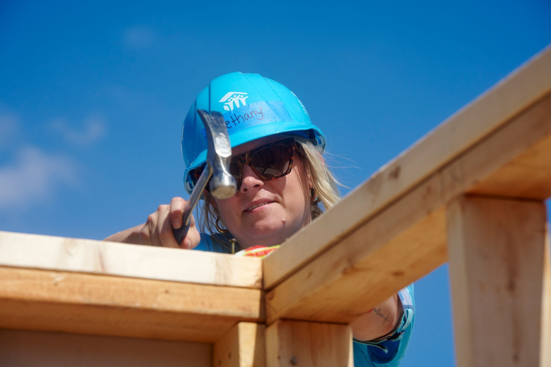 Woman hammering house