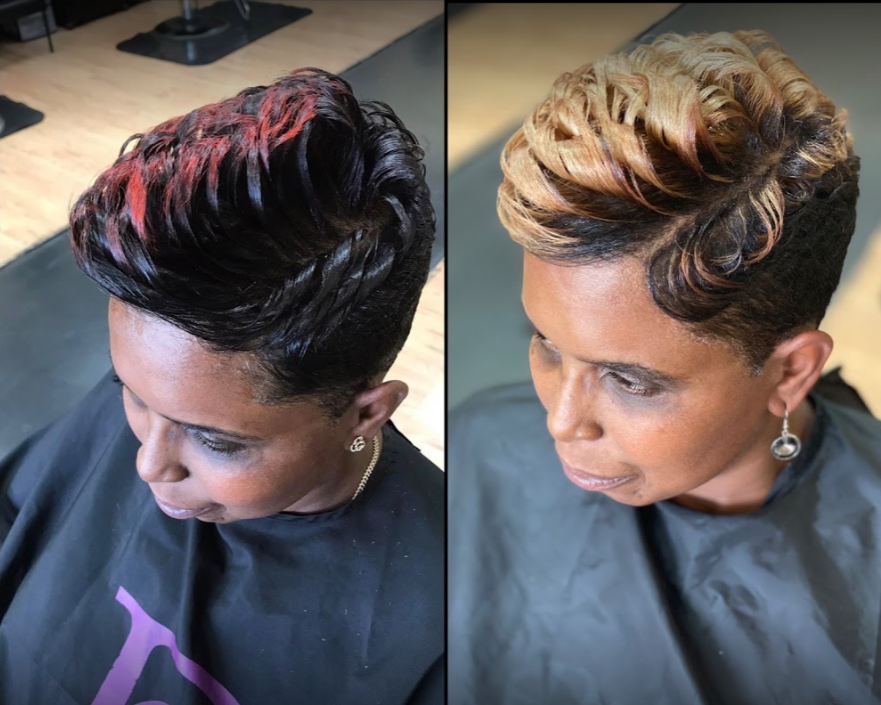 Woman with short hair styled in waves; one side shows dark hair with red highlights, the other shows blonde highlights.