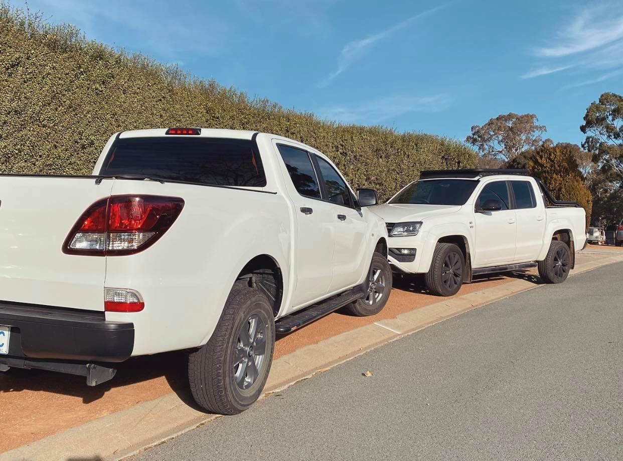 Two White Pickup Trucks Are Parked on the Side of the Road — Diamond Tints In Weston Creek, ACT