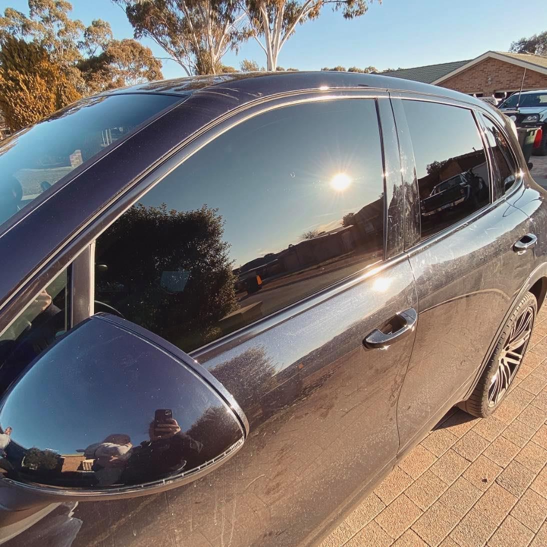 A Black Car is Parked in Front of a House — Diamond Tints In Tuggeranong, ACT