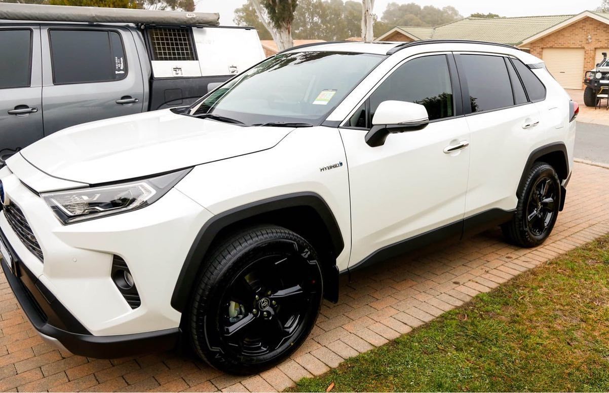 A White SUV With Black Wheels is Parked in a Driveway — Diamond Tints In Gungahlin, ACT