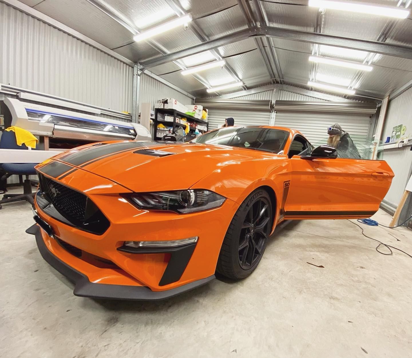 An Orange Mustang is Parked in a Garage With Its Doors Open — Diamond Tints In Woden, ACT