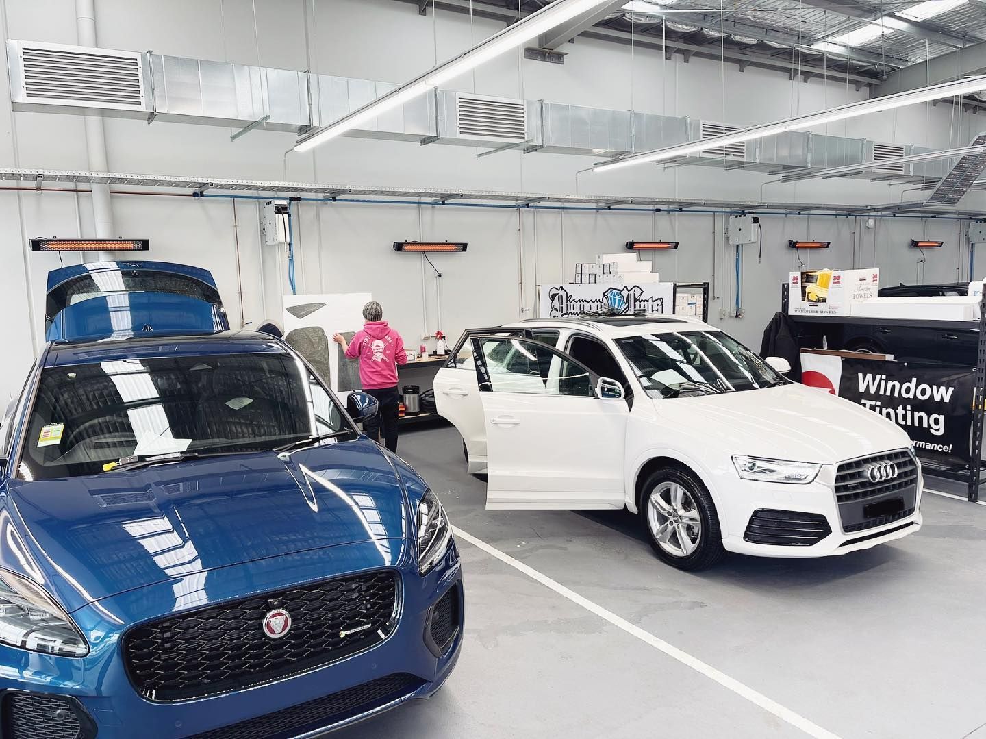 Two Cars Are Parked in a Garage With Their Doors Open — Diamond Tints In Phillip, ACT