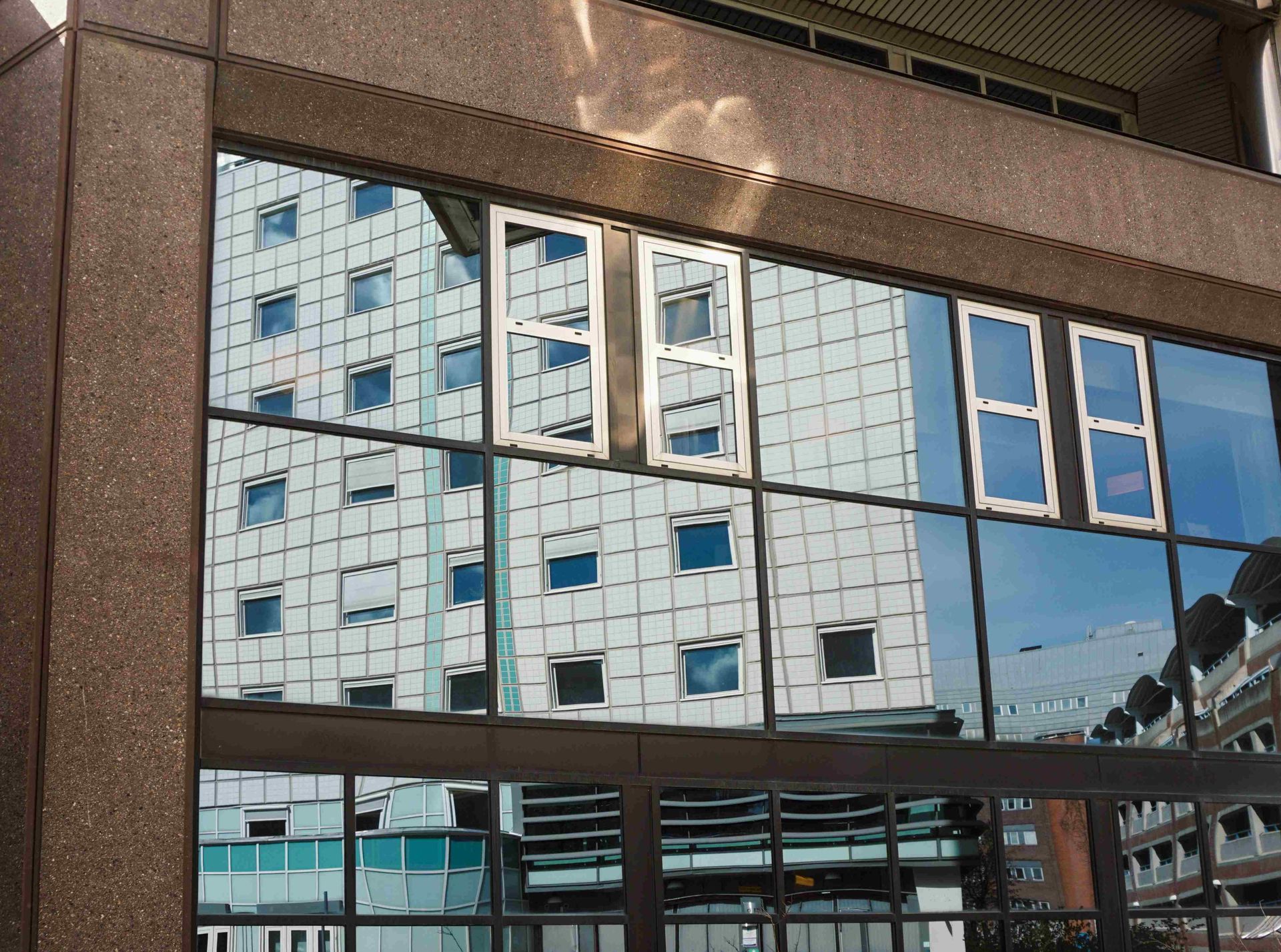 A Building With a Reflection of a Building in the Windows — Diamond Tints In Phillip, ACT