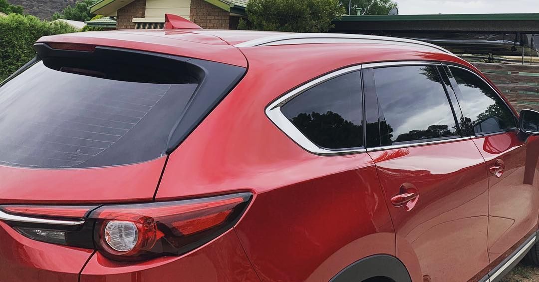 A Red Car is Parked in Front of a House — Diamond Tints In Cooma, ACT