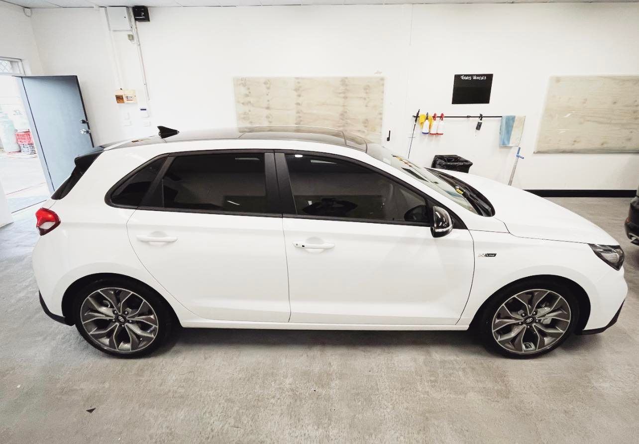 A White Hatchback Car is Parked in a Garage — Diamond Tints In Belconnen, ACT