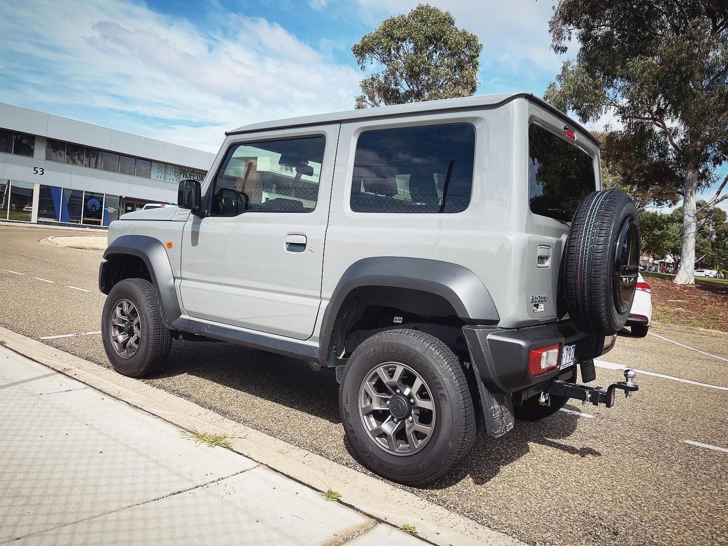 A grey jeep with tinted windows is parked on the side of the road — Diamond Tints In Queanbeyan, ACT
