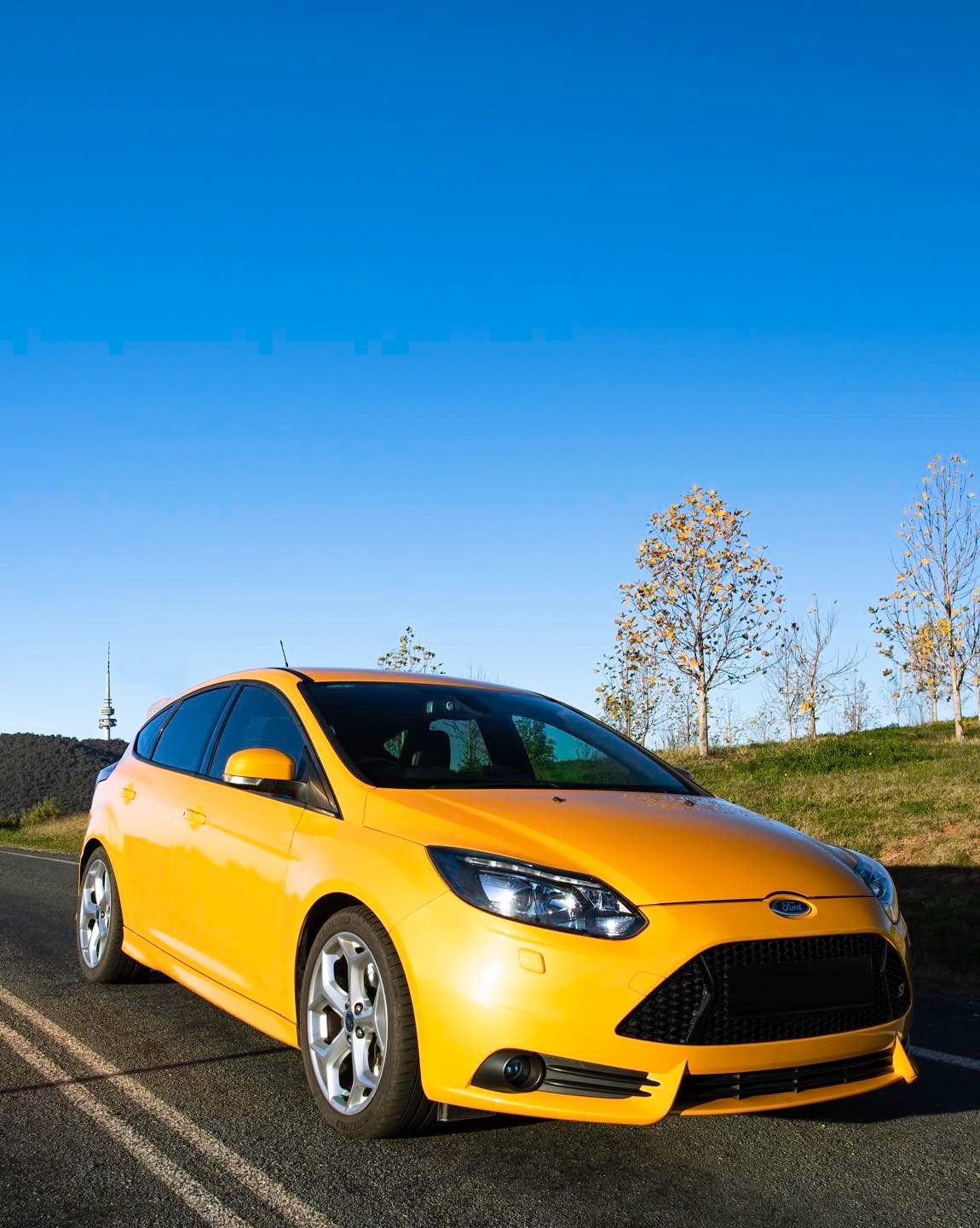 A Yellow Ford Focus is Parked on the Side of the Road — Diamond Tints In Belconnen, ACT
