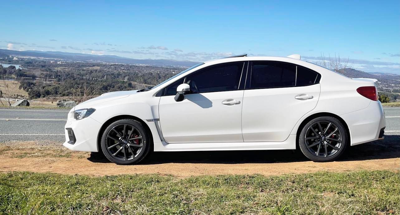A White Subaru is Parked on the Side of the Road — Diamond Tints In Phillip, ACT