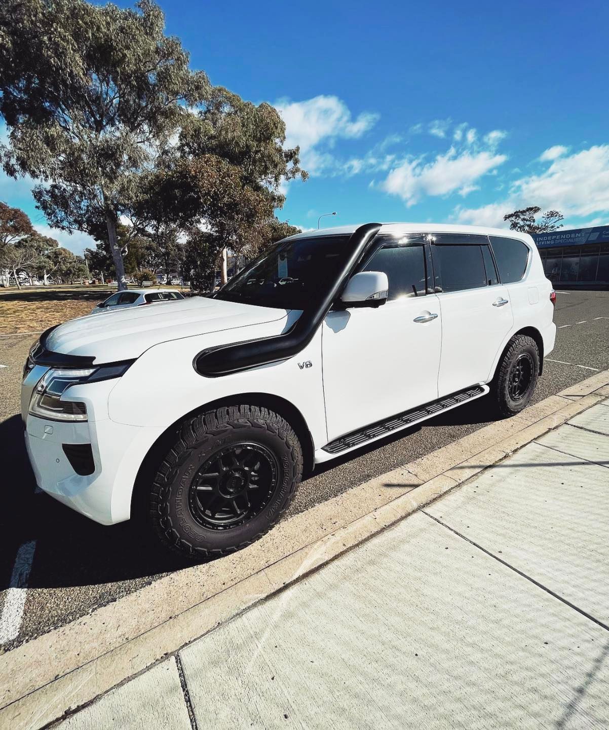 A White SUV With a Snorkel on the Hood is Parked on the Side of the Road — Diamond Tints In Goulburn, ACT