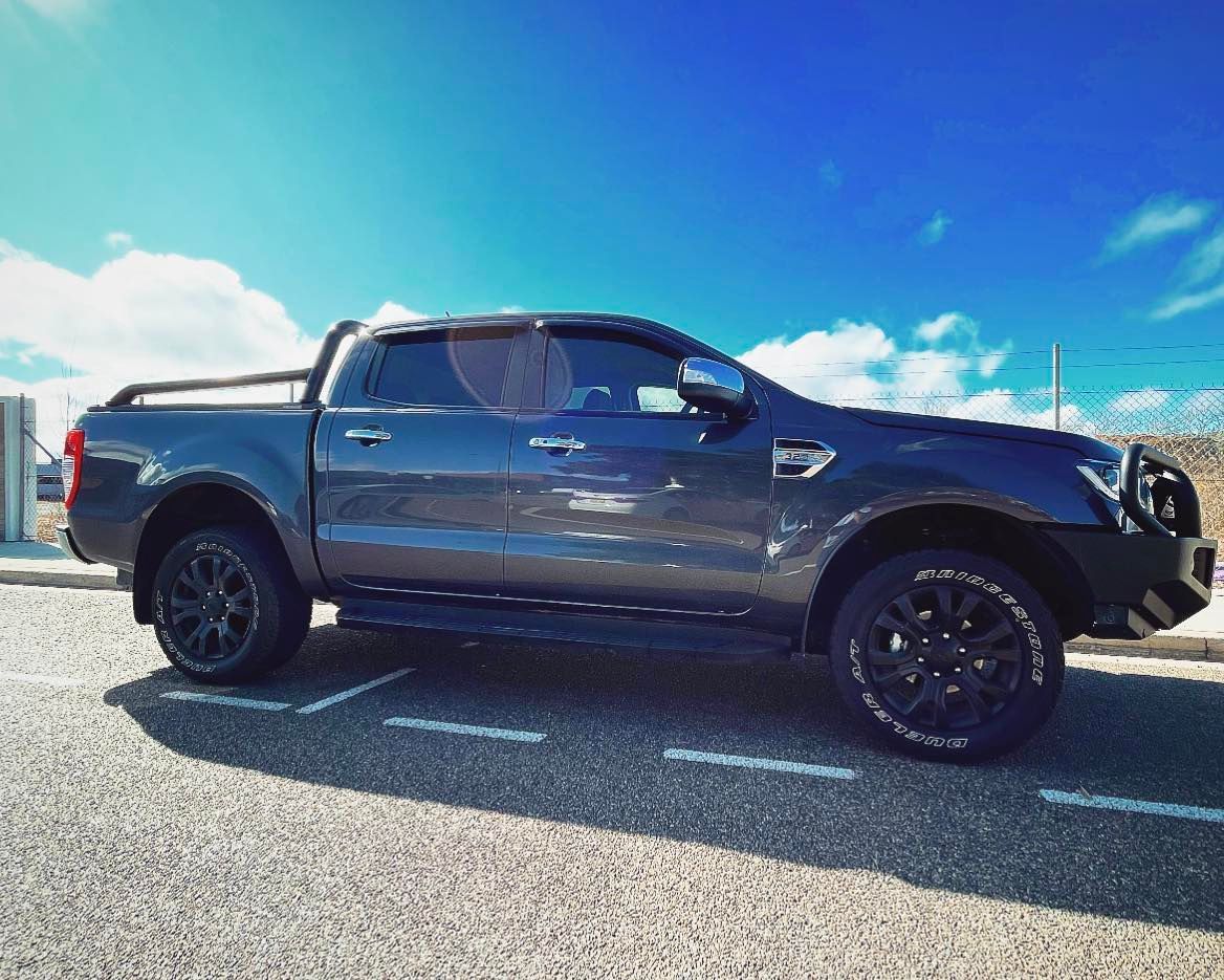 A Black Truck is Parked on the Side of the Road — Diamond Tints In Phillip, ACT