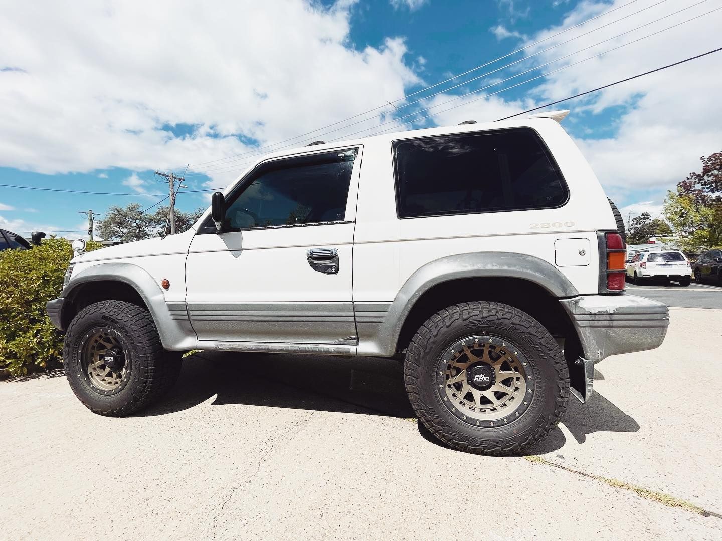 A White SUV is Parked on the Side of the Road — Diamond Tints In Phillip, ACT