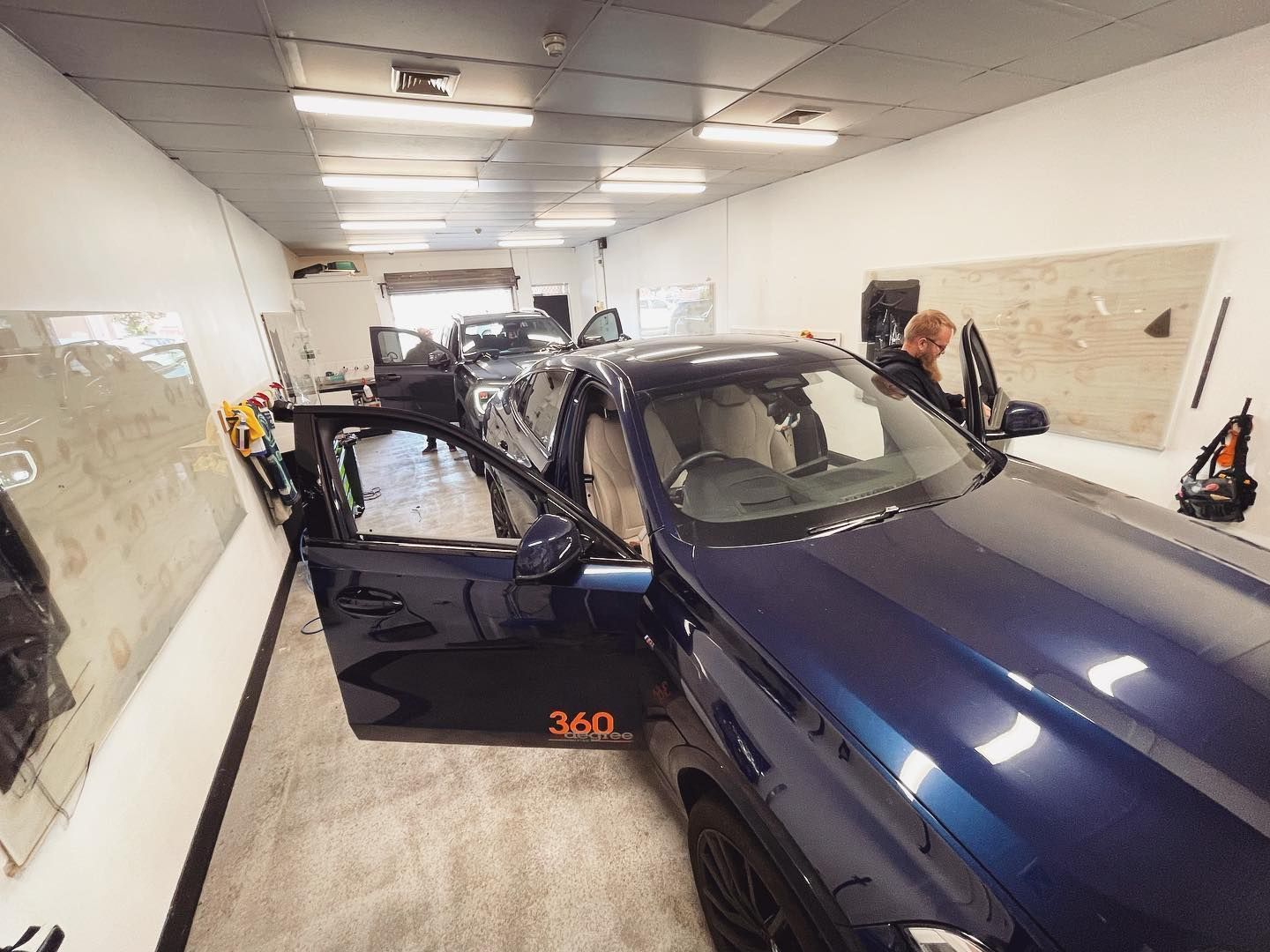 A Blue Car is Parked in a Garage With the Door Open — Diamond Tints In Phillip, ACT