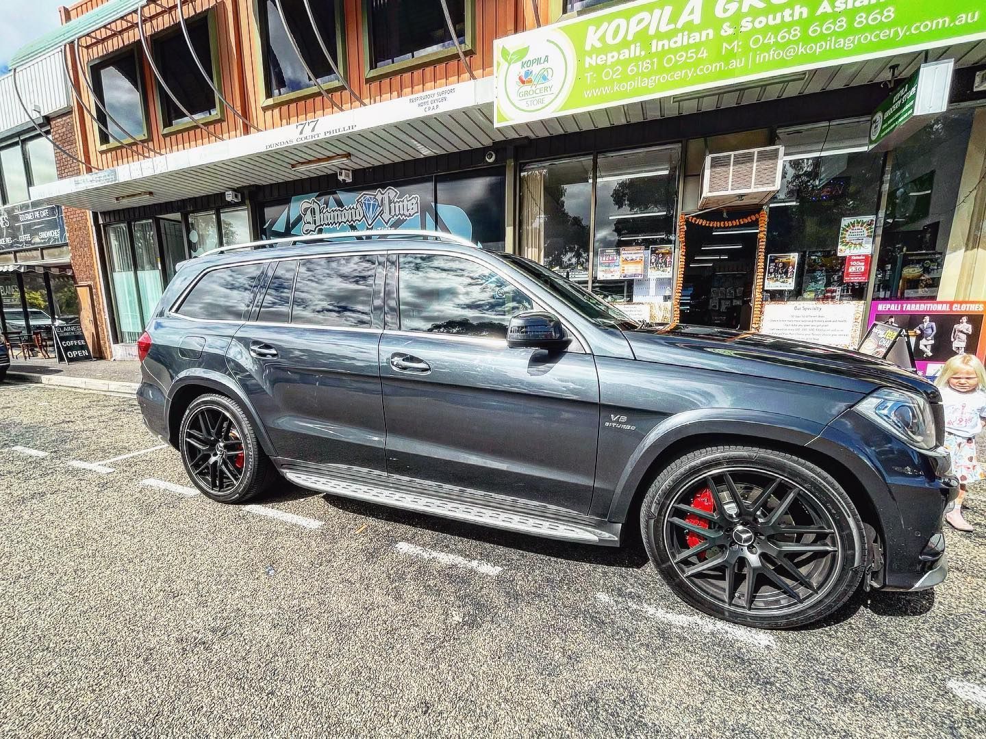 A Black Car is Parked in Front of a Building — Diamond Tints In Yass, ACT
