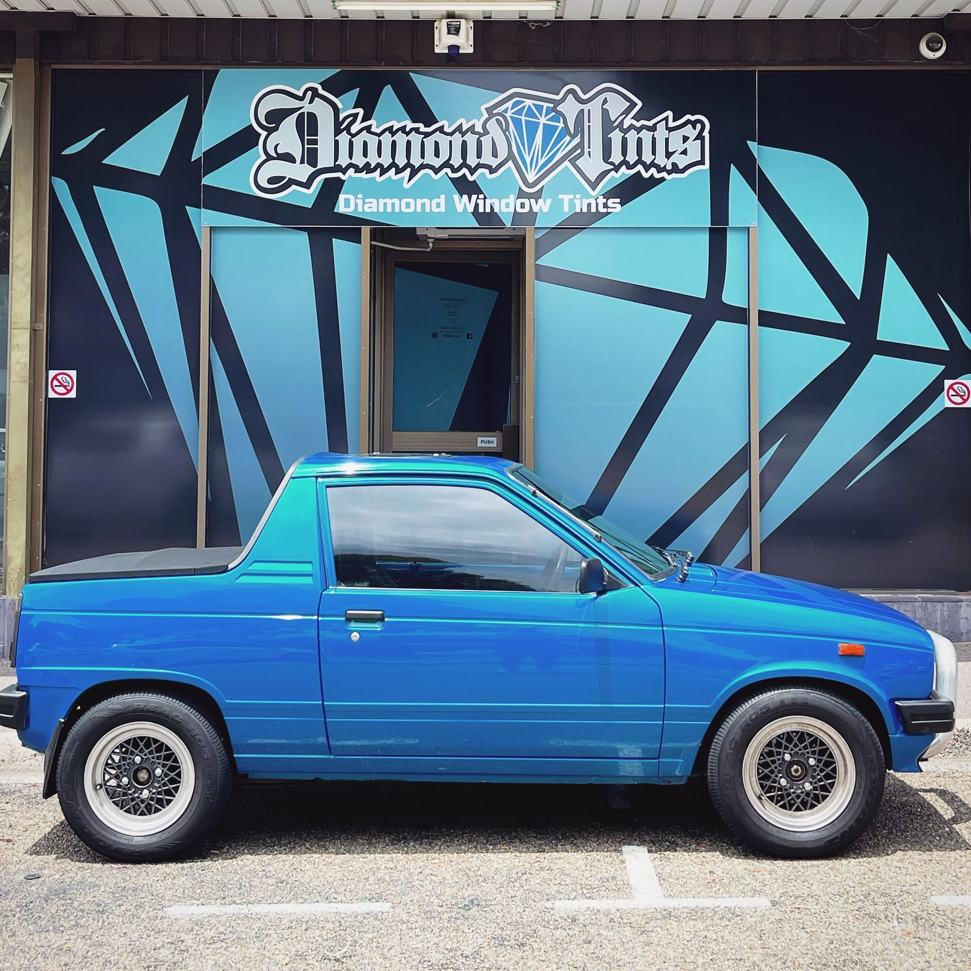 A Blue Truck is Parked in Front of a Diamond Window Tints Store — Diamond Tints In Bungendore, ACT