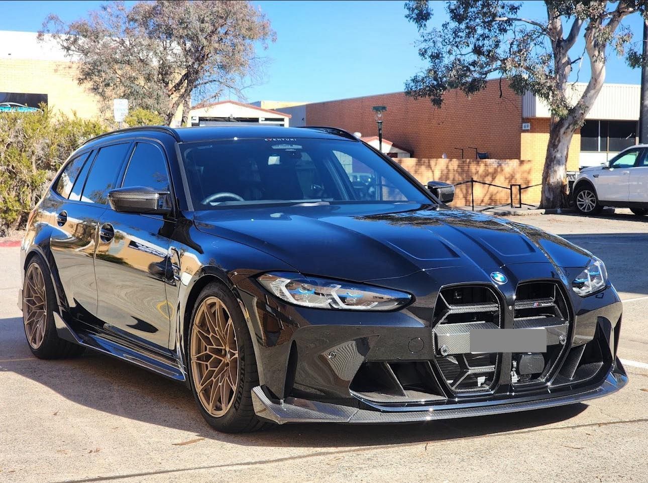 A Black BMW M3 Touring is Parked on the Side of the Road — Diamond Tints In Phillip, ACT
