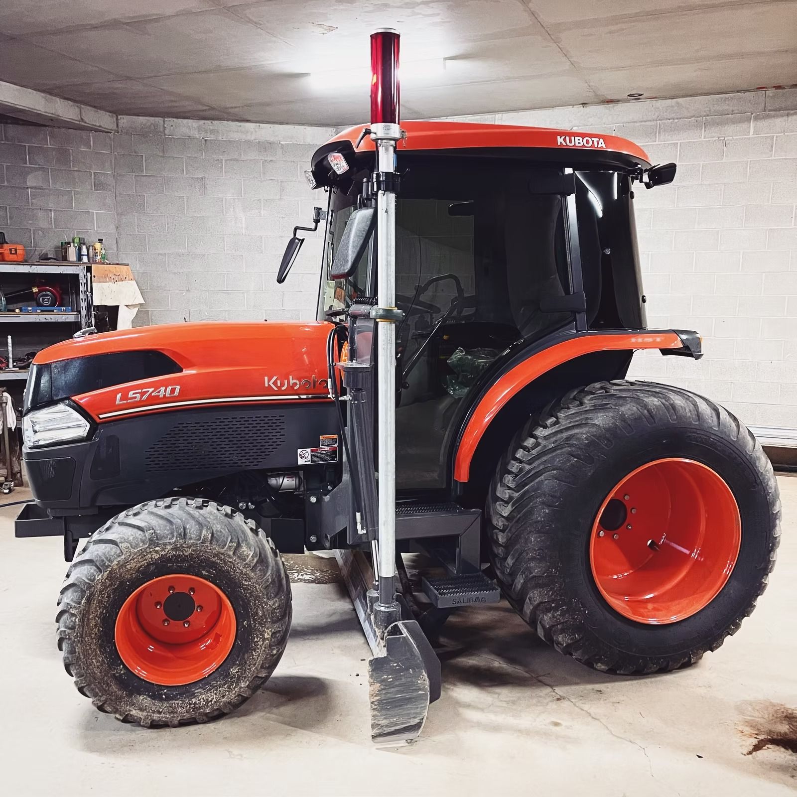 A red tractor with tinted windows is parked in a workshop — Diamond Tints In Bungendore, ACT