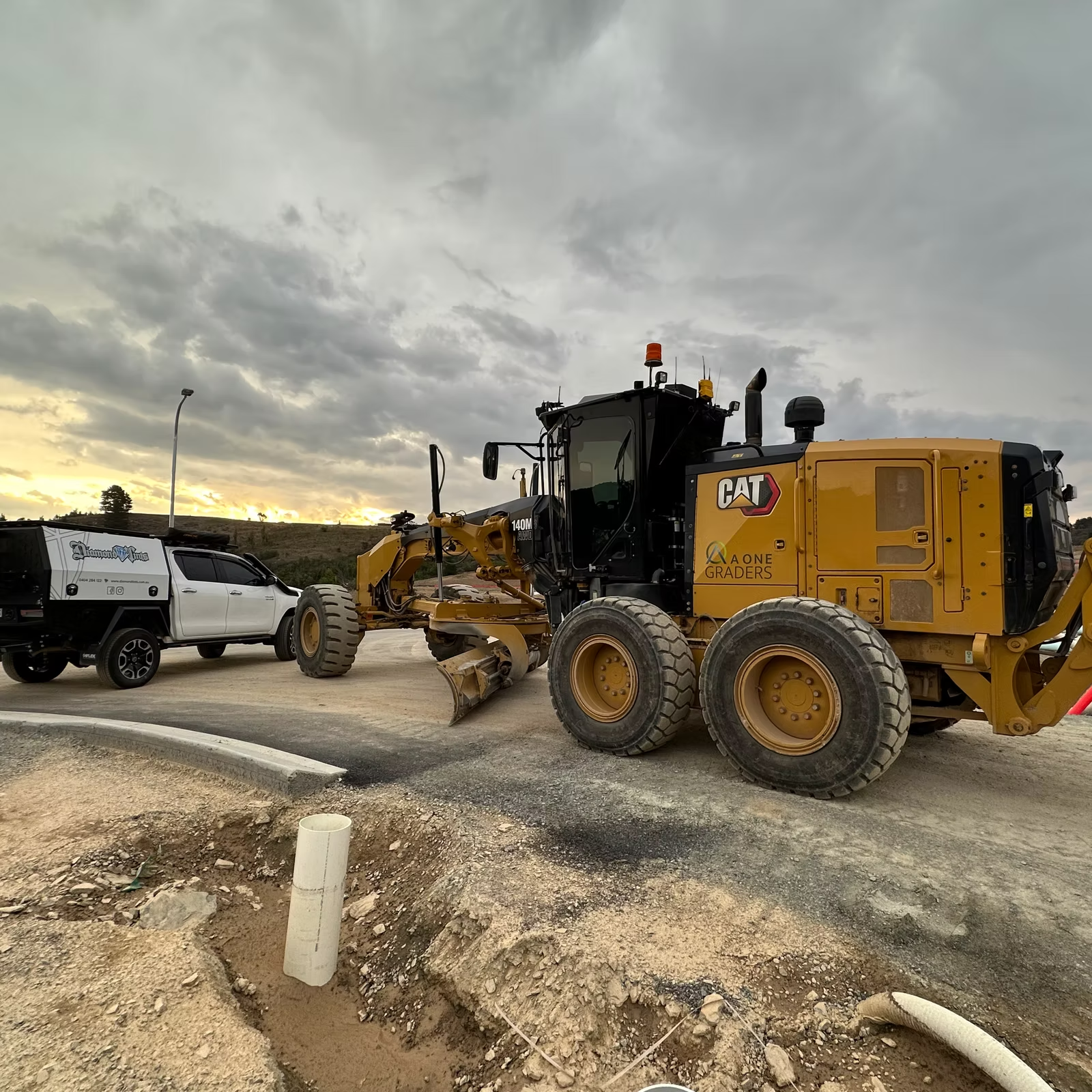 A Bulldozer is Sitting on the Side of a Road Next to a Truck — Diamond Tints In Phillip, ACT