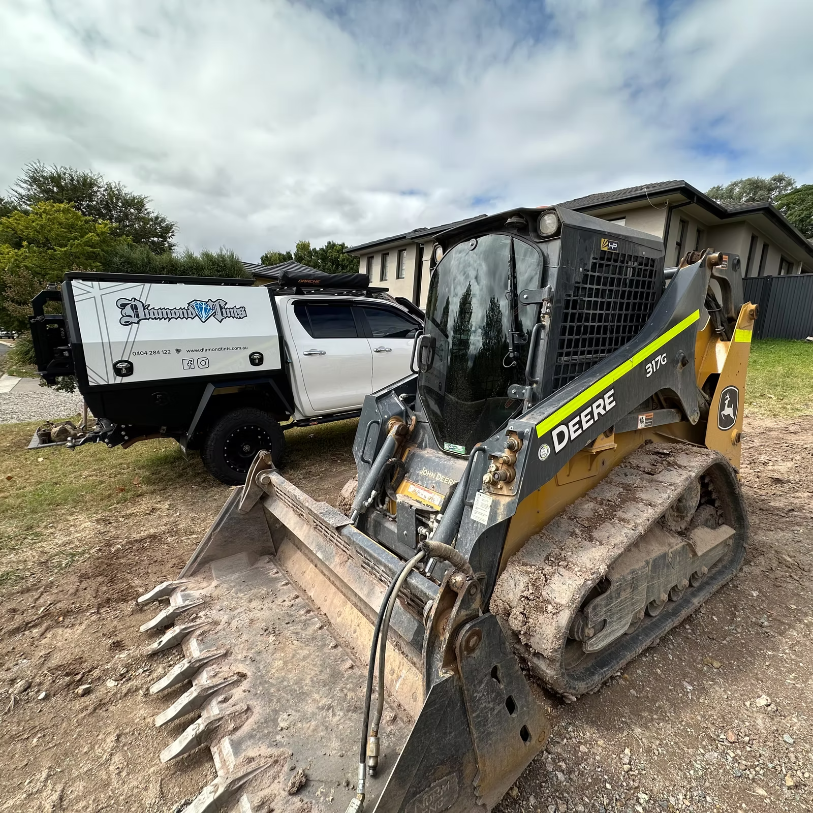 A White ute is parked next to a Yellow tractor — Diamond Tints In Yass, ACT