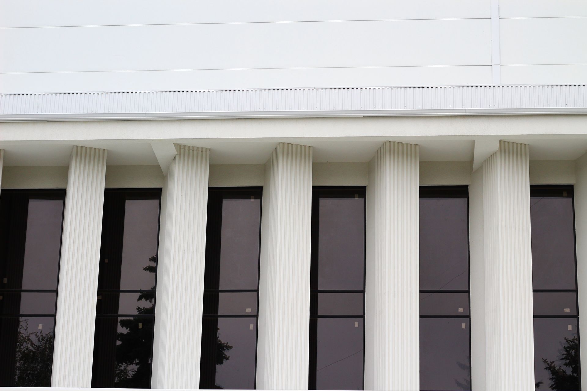 A White building with white poles and long tinted windows — Diamond Tints In Woden, ACT