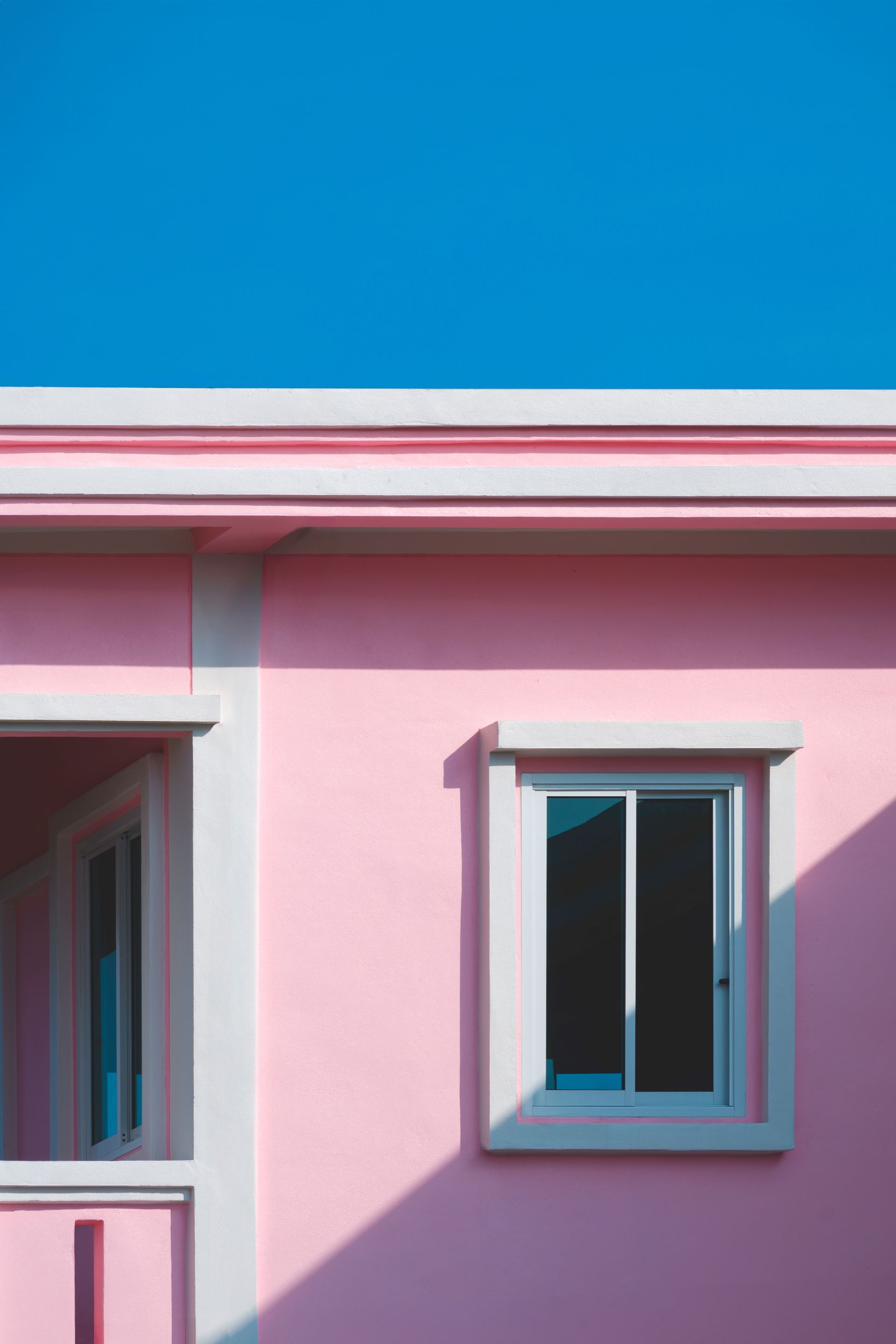 A Close Up of a Pink House With a Blue Sky in the Background — Diamond Tints In Tuggeranong, ACT