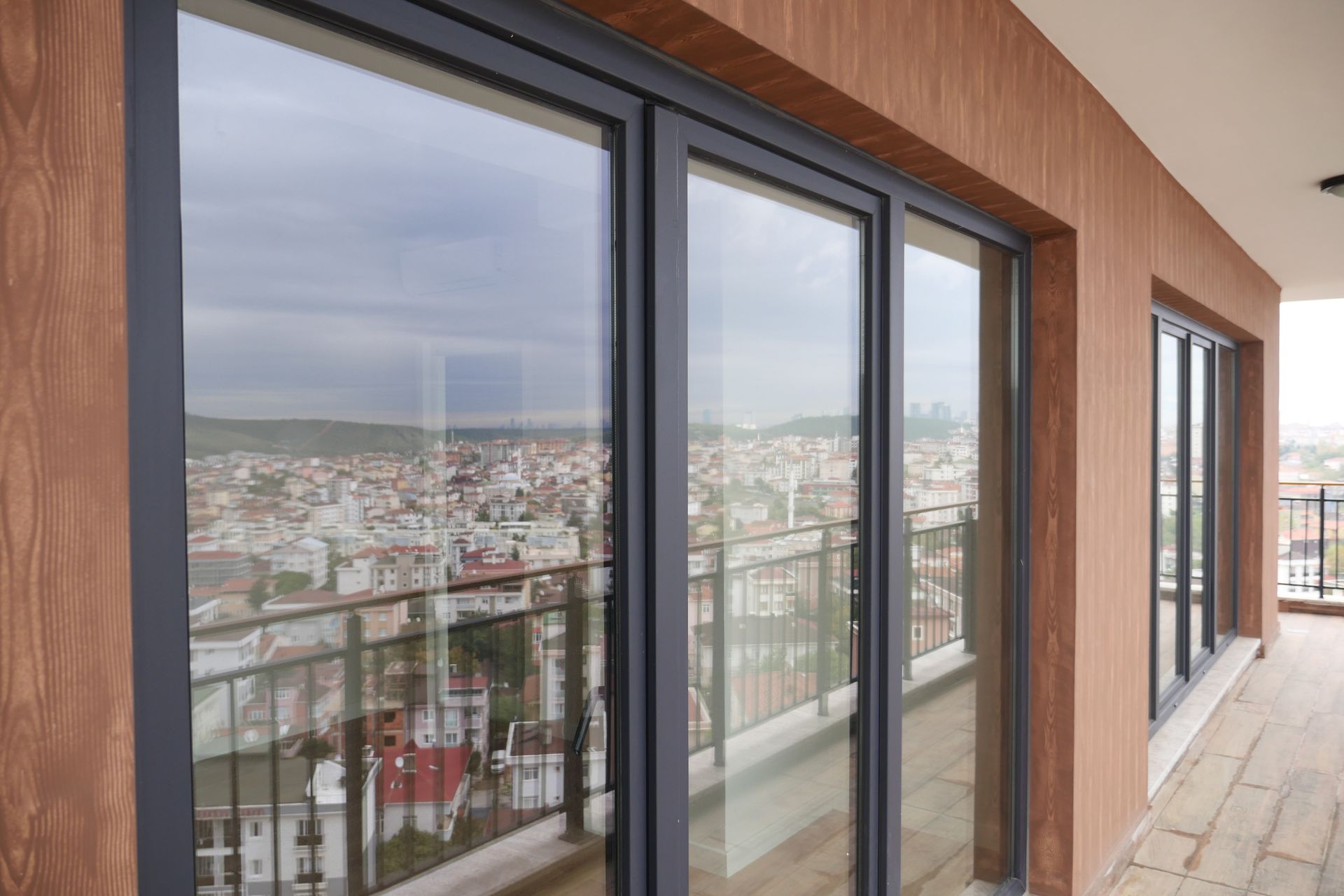 A Balcony With Sliding Glass Doors and a View of a City — Diamond Tints In Belconnen, ACT
