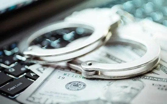 Handcuff With Money Under The Laptop — Eau Claire, WI — Cohen Law Offices