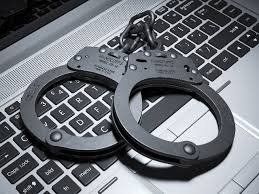 Handcuffs on Laptop — Eau Claire, WI — Cohen Law Offices