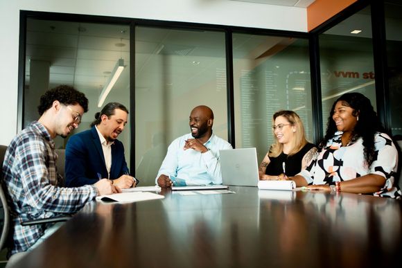 E&B Team sitting around a conference table having a meeting.