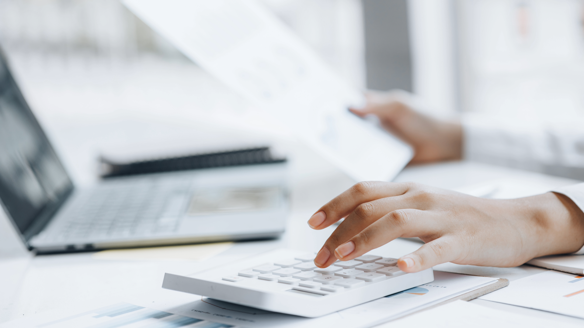 Photo showing a persons hands balancing books