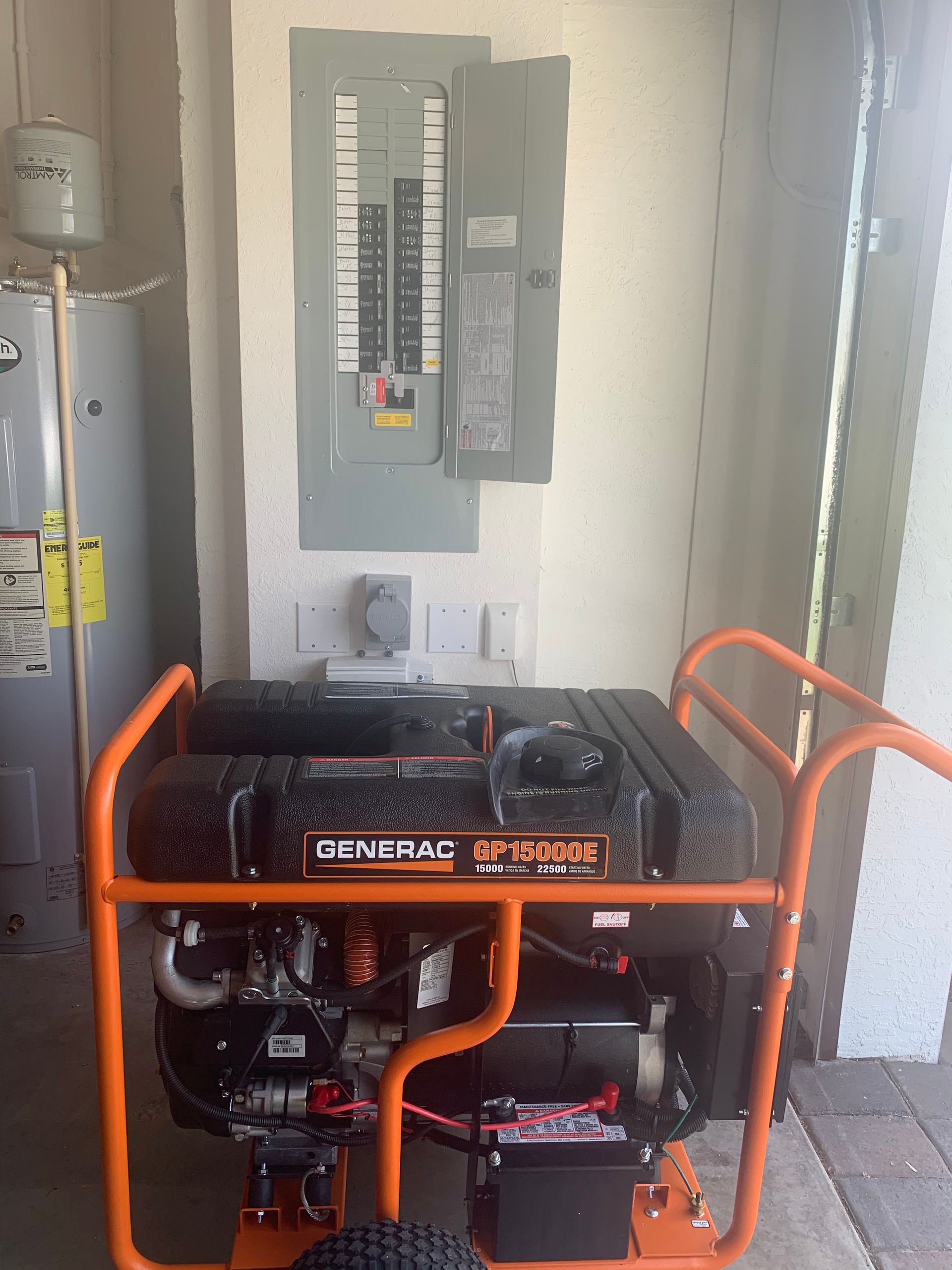 A generator is sitting in a room next to a water heater.