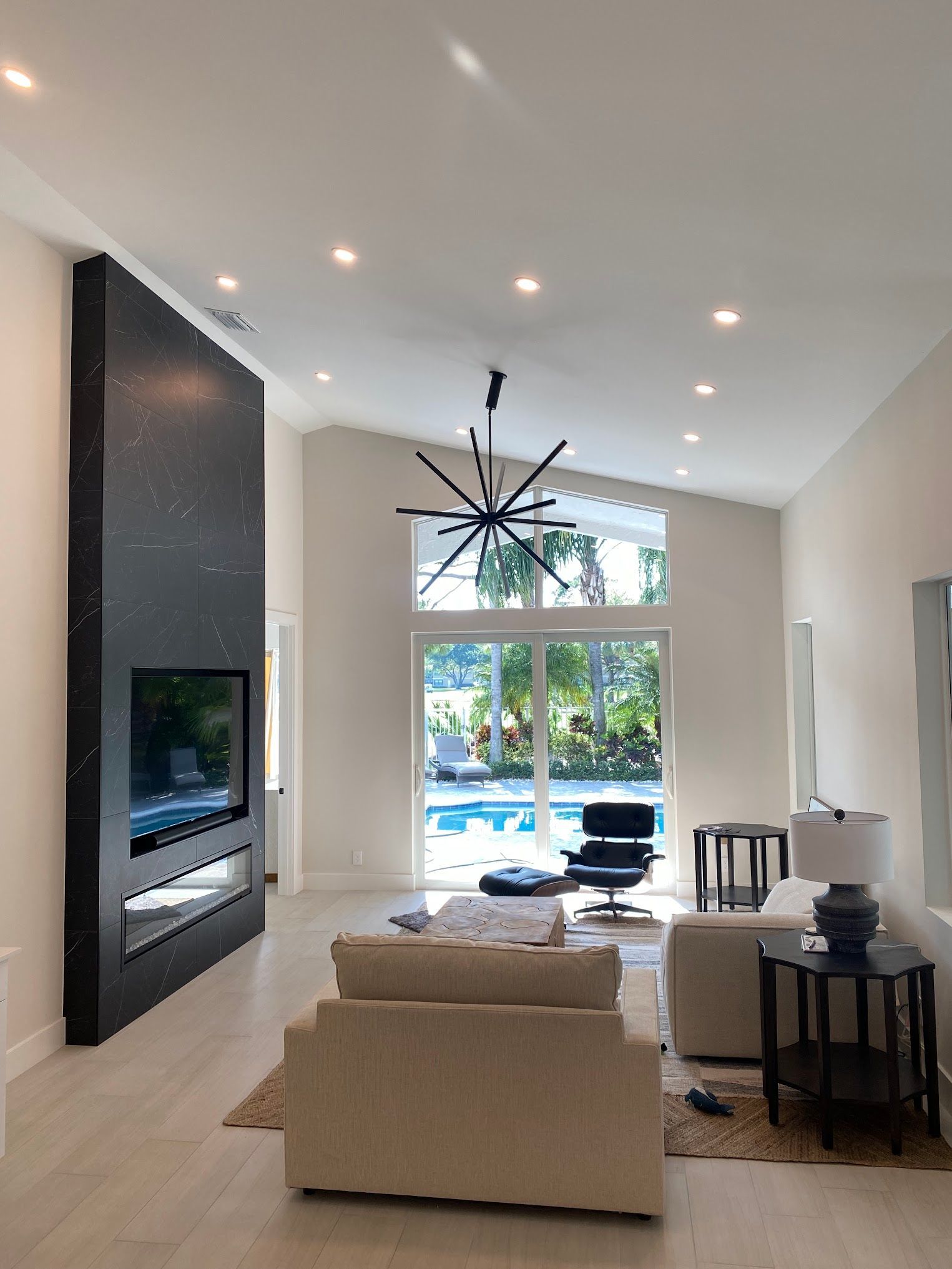 A living room with a large flat screen tv on the wall
