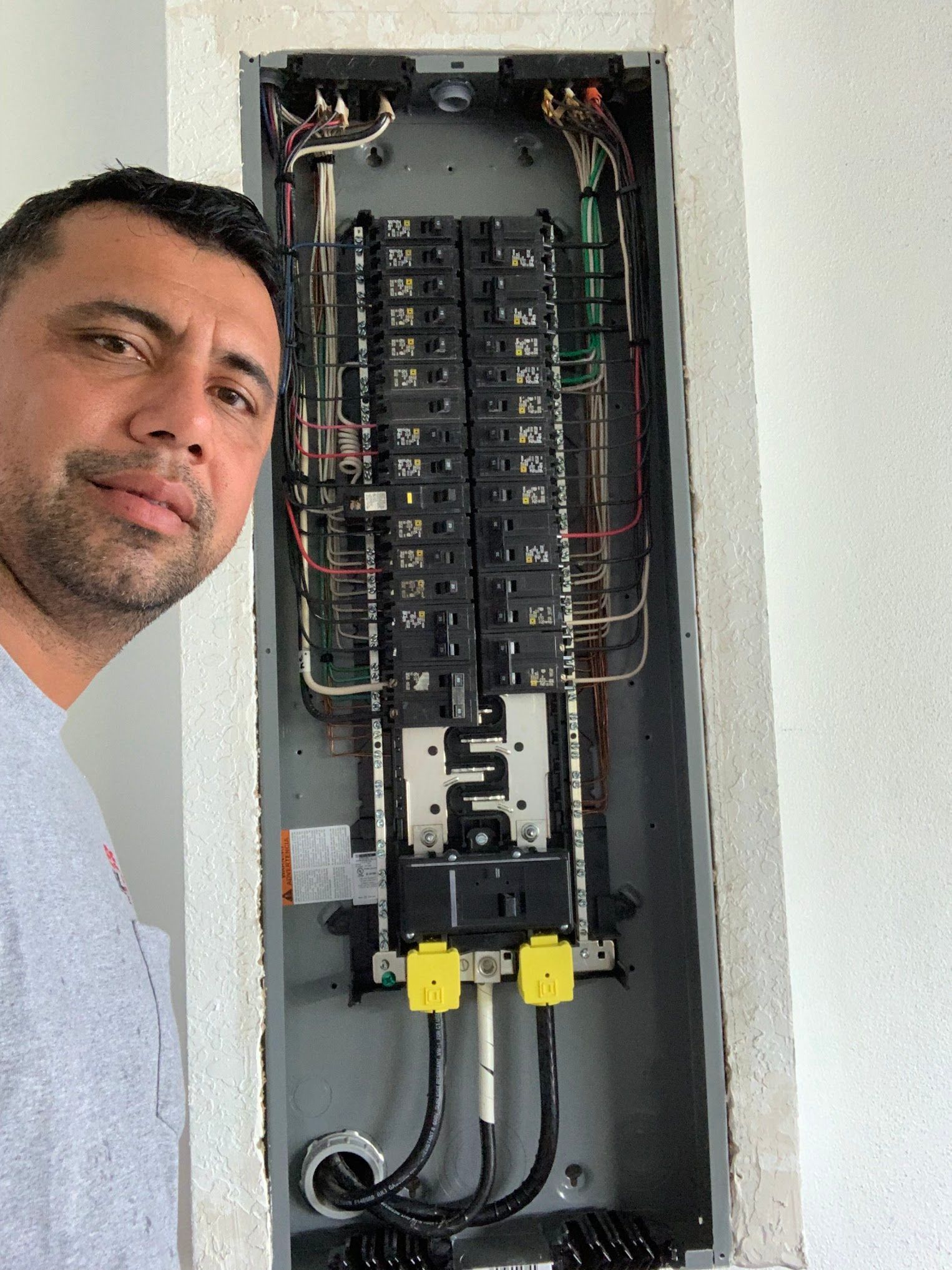 A man is standing in front of an electrical box.