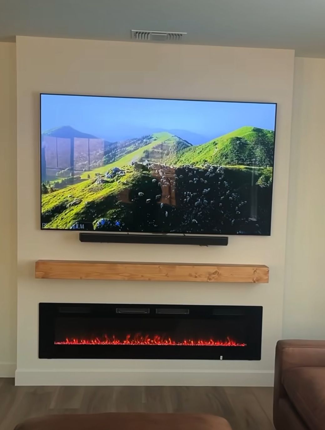 A living room with a fireplace and a flat screen tv