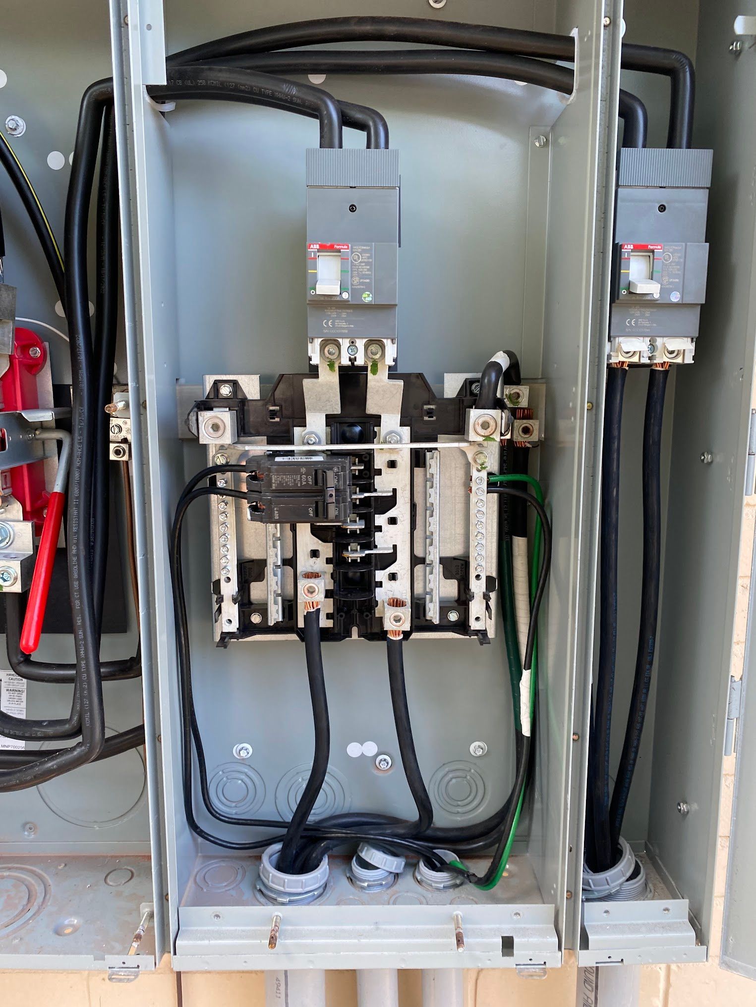 A close up of an electrical box with a lot of wires coming out of it.