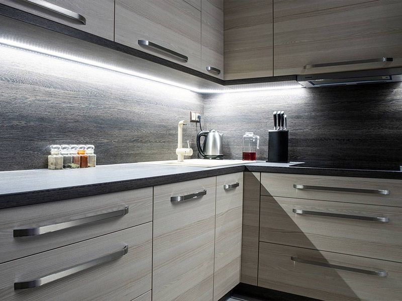 A kitchen with wooden cabinets and a counter top