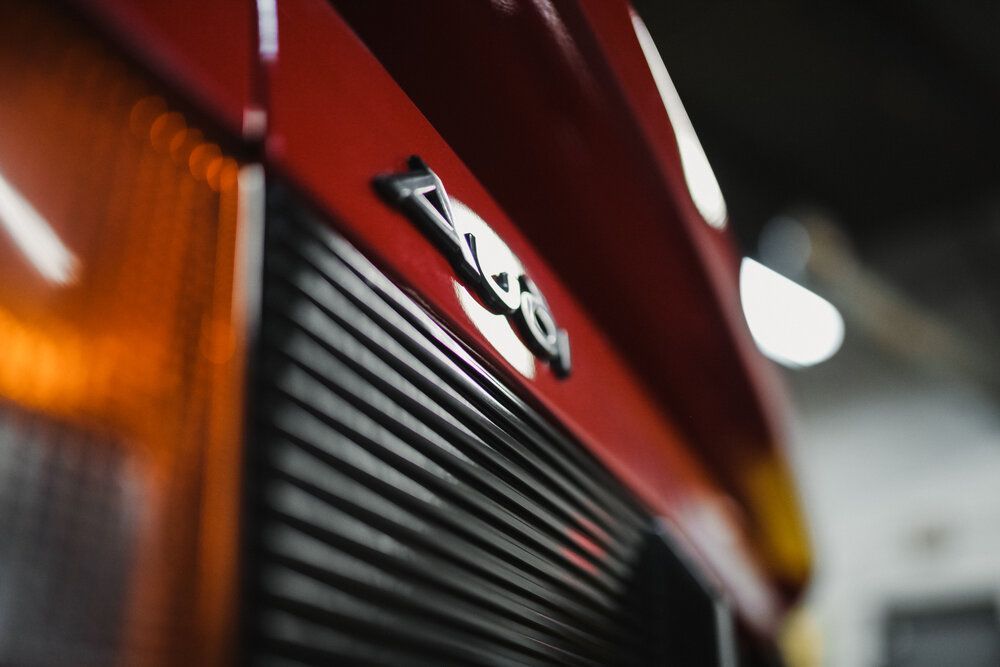 A close up of a red car with the word ferrari on it