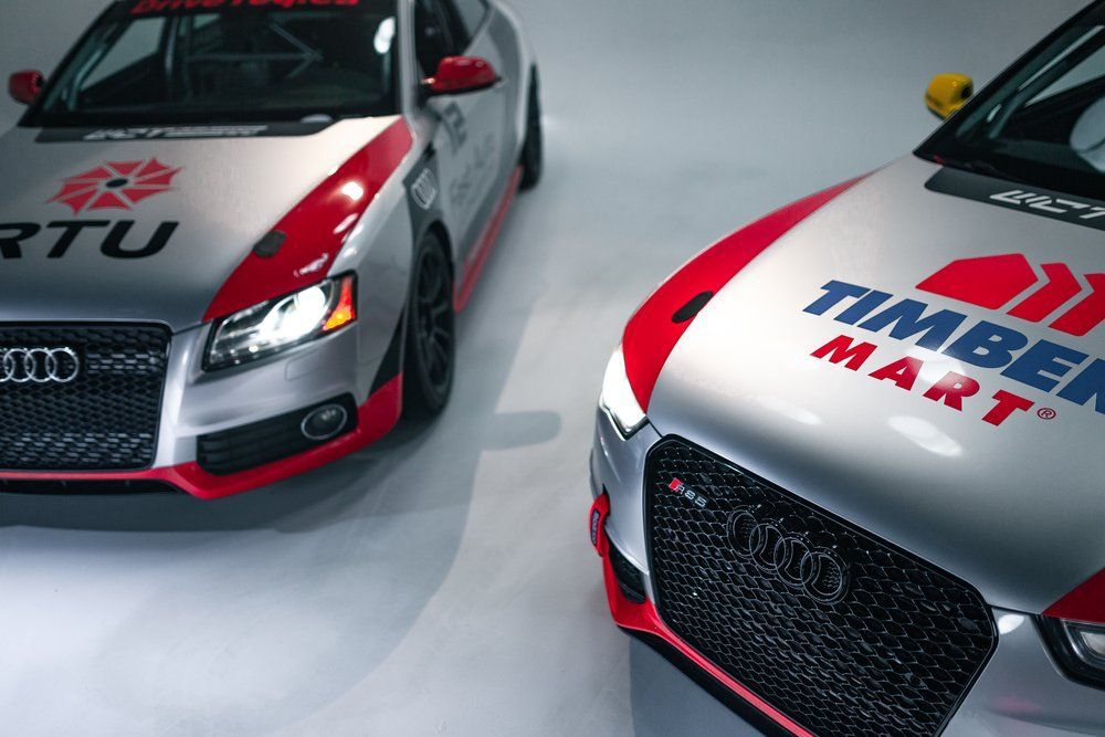 Two cars with timber mart written on the hoods