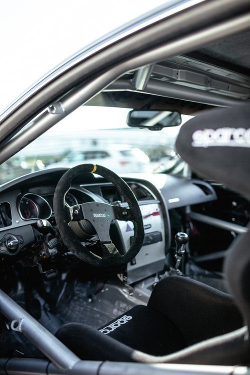 The inside of a race car with the word sparco on the seat
