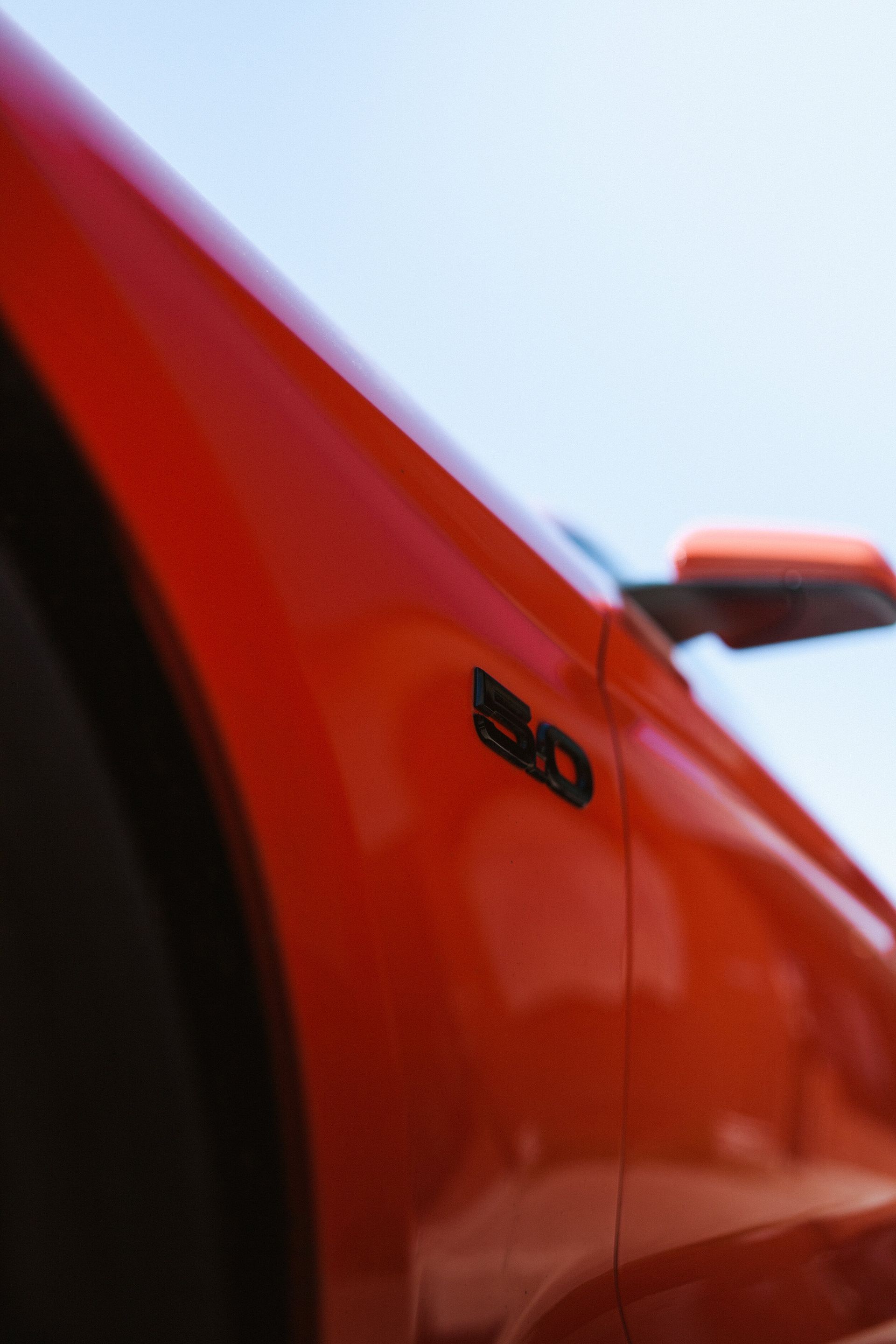 A close up of a red car with a black emblem that says 50