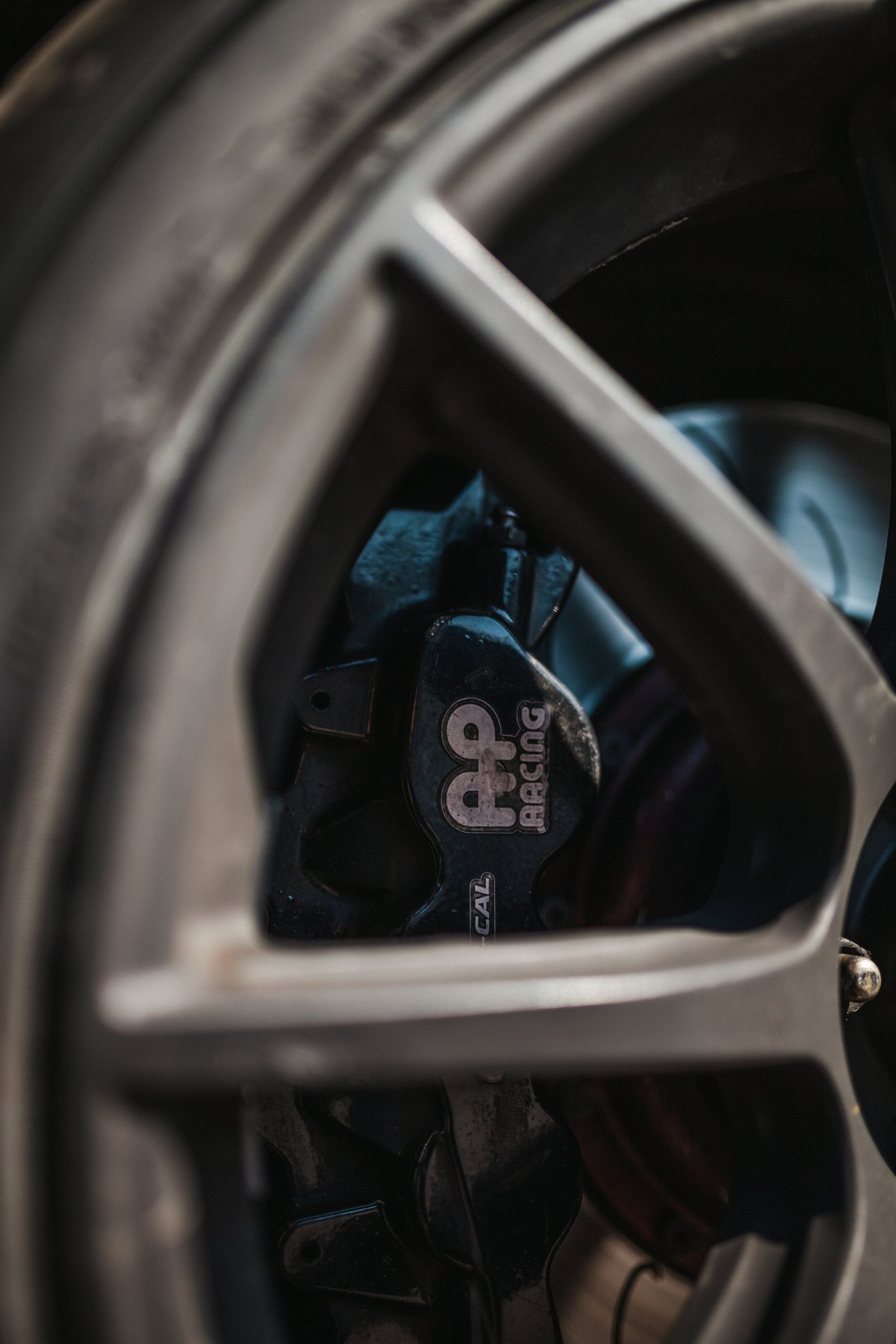 A close up of a car wheel with a brake pad on it.