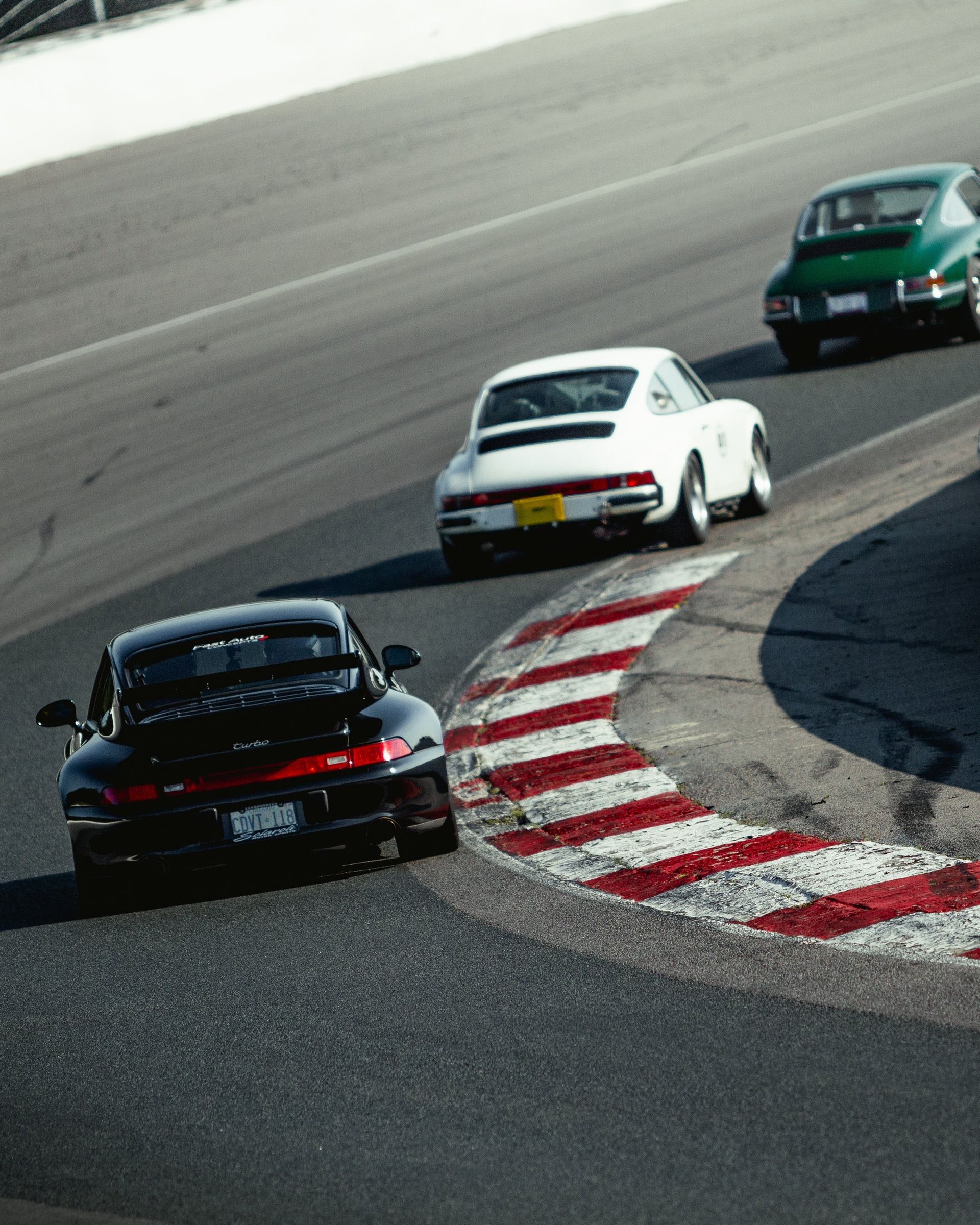 A group of cars are racing on a race track