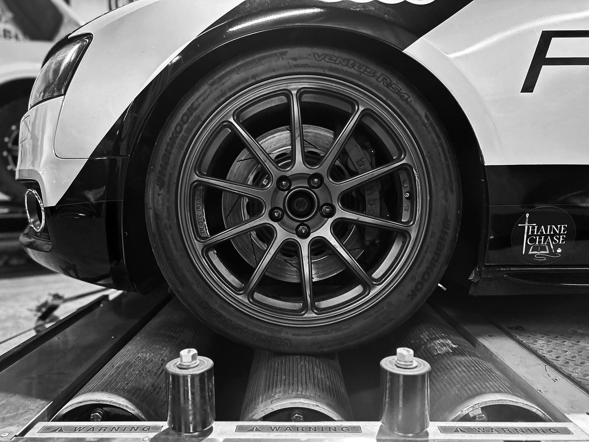 A black and white photo of a car with the letter f on the side.