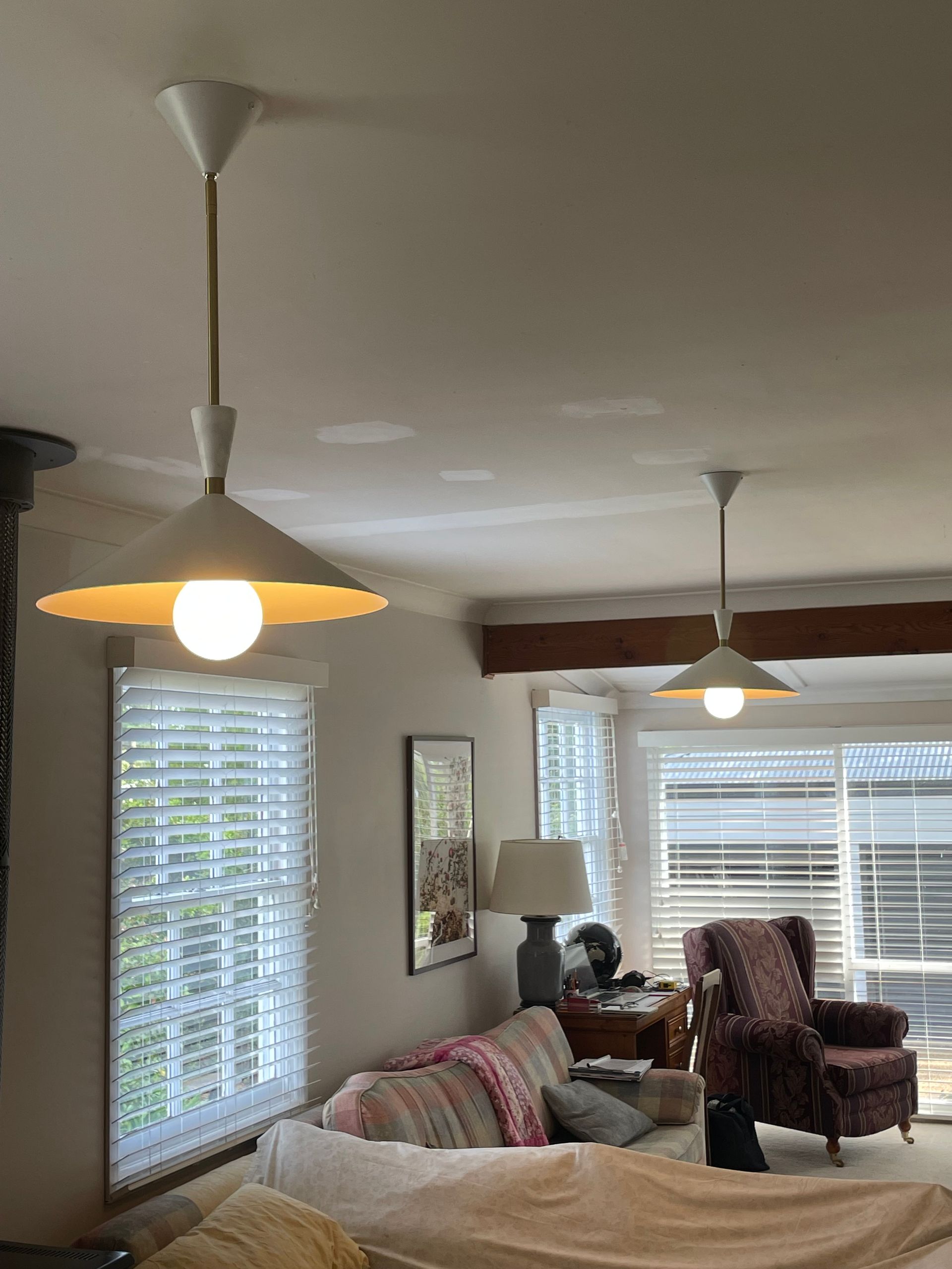 Living room with sofas, recliner, floor lamp, ceiling lights, and large windows with blinds. — Technik Electrical in Bowral, NSW
