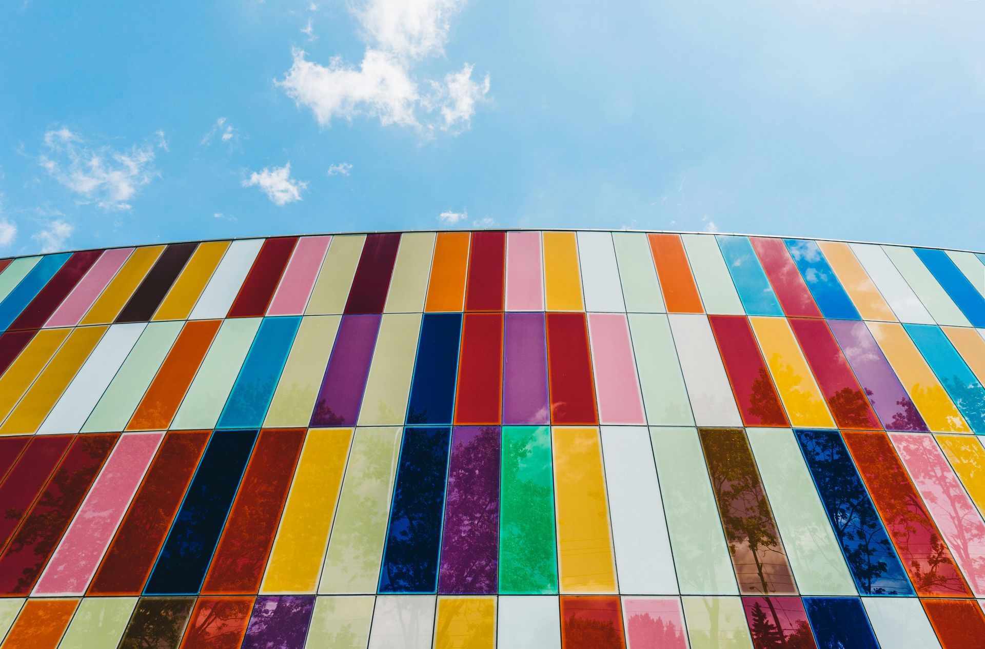 Looking up at a colorful building with a blue sky in the background.