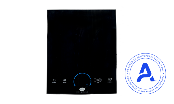 Woman in straw hat smiles, holding wine glass near a lake.